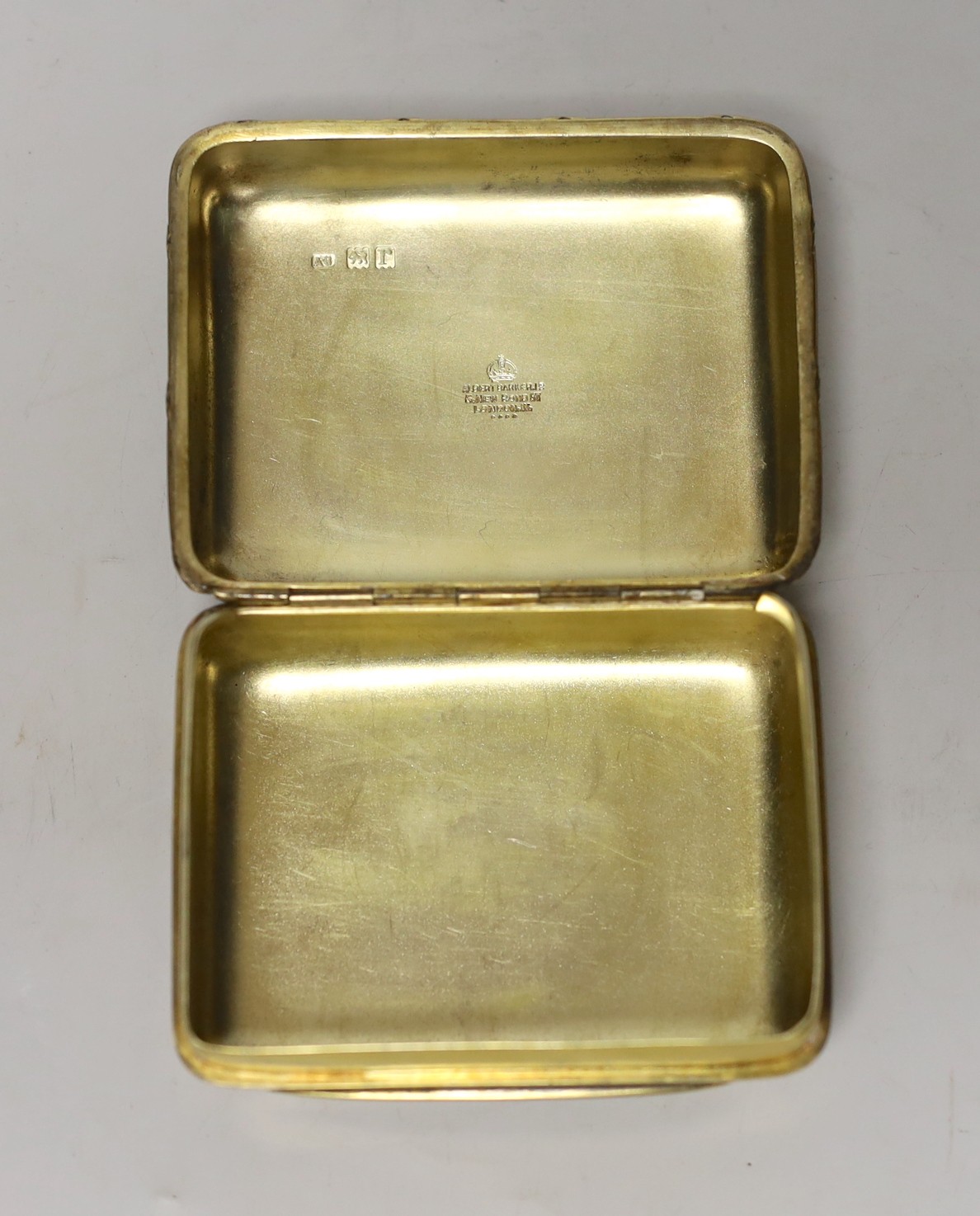A George V silver gilt box and cover, by Albert Barker, London, 1913, the cover later? enamelled with a reclining nude, 90mm, gross weight 4.9 oz.